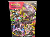La boîte est remplie de cartes à collectionner Pokémon sur fond noir.