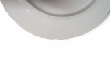 a close up of a white bowl with a spoon in it