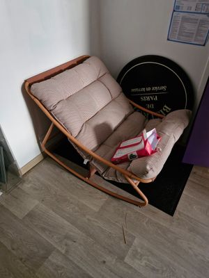 a rocking chair in a corner of a room next to a door