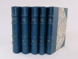 six blue books are lined up in a row on a white surface