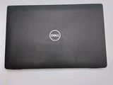 the dell laptop is sitting on a table with its lid open