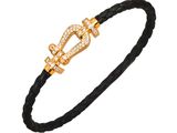 a black braid bracelet with a gold clasp and a diamond clasp