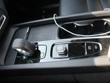 the interior of a car with a cell phone in the center console