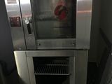a silver oven that is sitting in the middle of a room