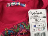 a tag that says dessignual on a colorful shirt