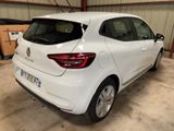 the rear end of a white car parked in a garage