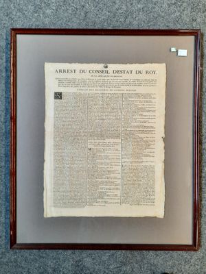 an old newspaper is hanging on a wall next to a pair of scissors