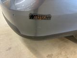 a close up of a car ' s bumper with a sticker on it