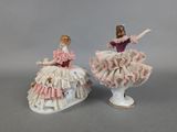pair of porcelain figurines of a woman in a pink dress and a woman in a pink dress