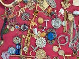 many different types of jewelry on display in a display case