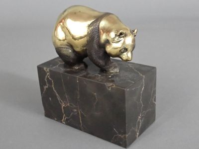 statue of a bear on a marble block on a gray background