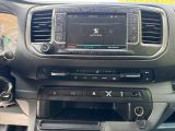 a car dashboard with a radio and a steering wheel