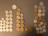 a lot of coins on the wall next to each other