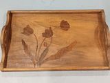 a wooden tray with flowers on it on a wall