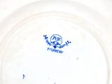 a white plate with a blue and white design on it