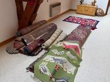 many rugs laid out on the floor in a room