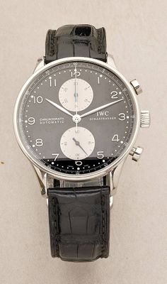 a close up of a wrist watch with a black leather strap