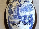 a blue and white vase hanging on the wall