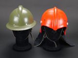 two helmets are sitting next to each other on a mannequin head