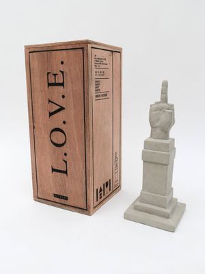 the statue is next to a box with a statue on it