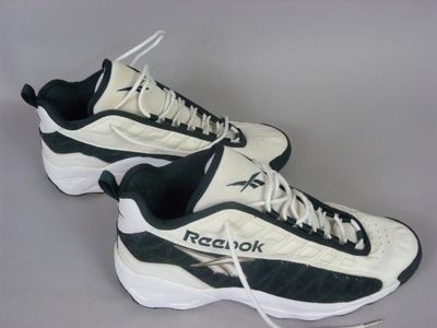 they are two pairs of reebok shoes on a gray surface