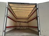 a white truck with a red stripe in the back of it