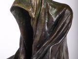 statue of a woman with a hood on her head