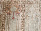 a very old rug with many designs on it