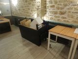 a couch and a table in a room with a stone wall