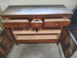 a wooden dresser with drawers and drawers in it