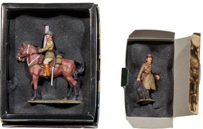 two figurines of a man riding a horse in a box