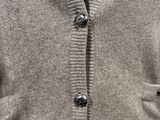 a close up of a man wearing a sweater and tie