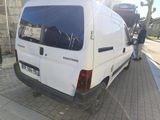a white van that is parked on the side of the street