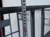 a measuring tape that is attached to a metal railing