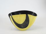 yellow and black ceramic bowl with a curved design on the side