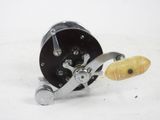 a close up of a reel and a potato on a white surface