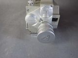 a silver camera sitting on top of a table
