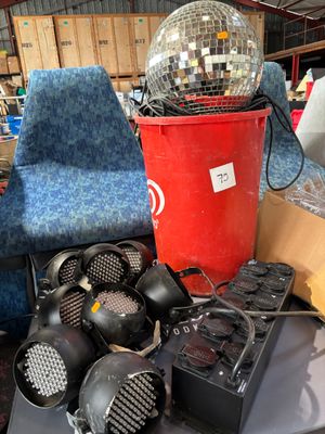 a table with a disco ball, speakers, and a chair