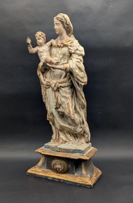 a statue of a woman holding a child in her arms