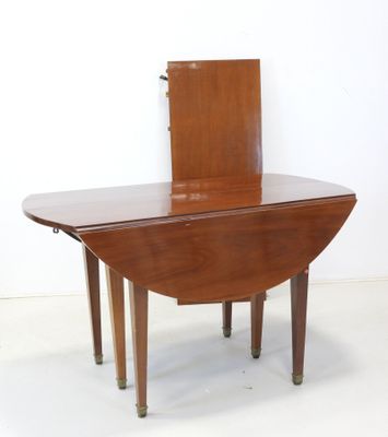 a small wooden table with a mirror on top of it