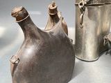 three metal vases sitting next to each other on a table