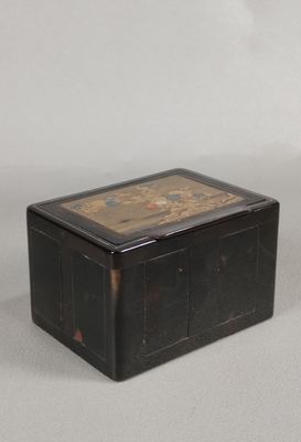 a black box with a painting on it on a table