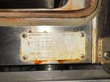 a dirty oven that has a metal plate on it
