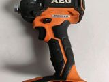 a close up of a cordless drill on a white surface