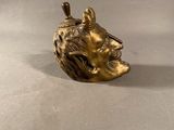 a gold figurine of a man with a hat on his head