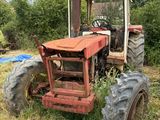 un tracteur qui est garé dans l'herbe, dans le champ