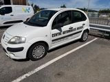a small white car parked in a parking lot