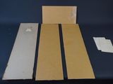 two pieces of cardboard are sitting on a table next to a piece of cardboard