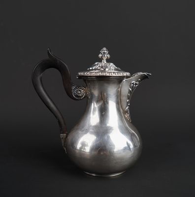 an antique silver coffee pot on a black background with a black background