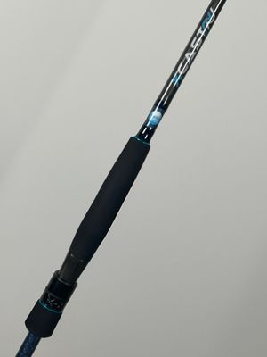 a close up of a fishing rod on a white surface